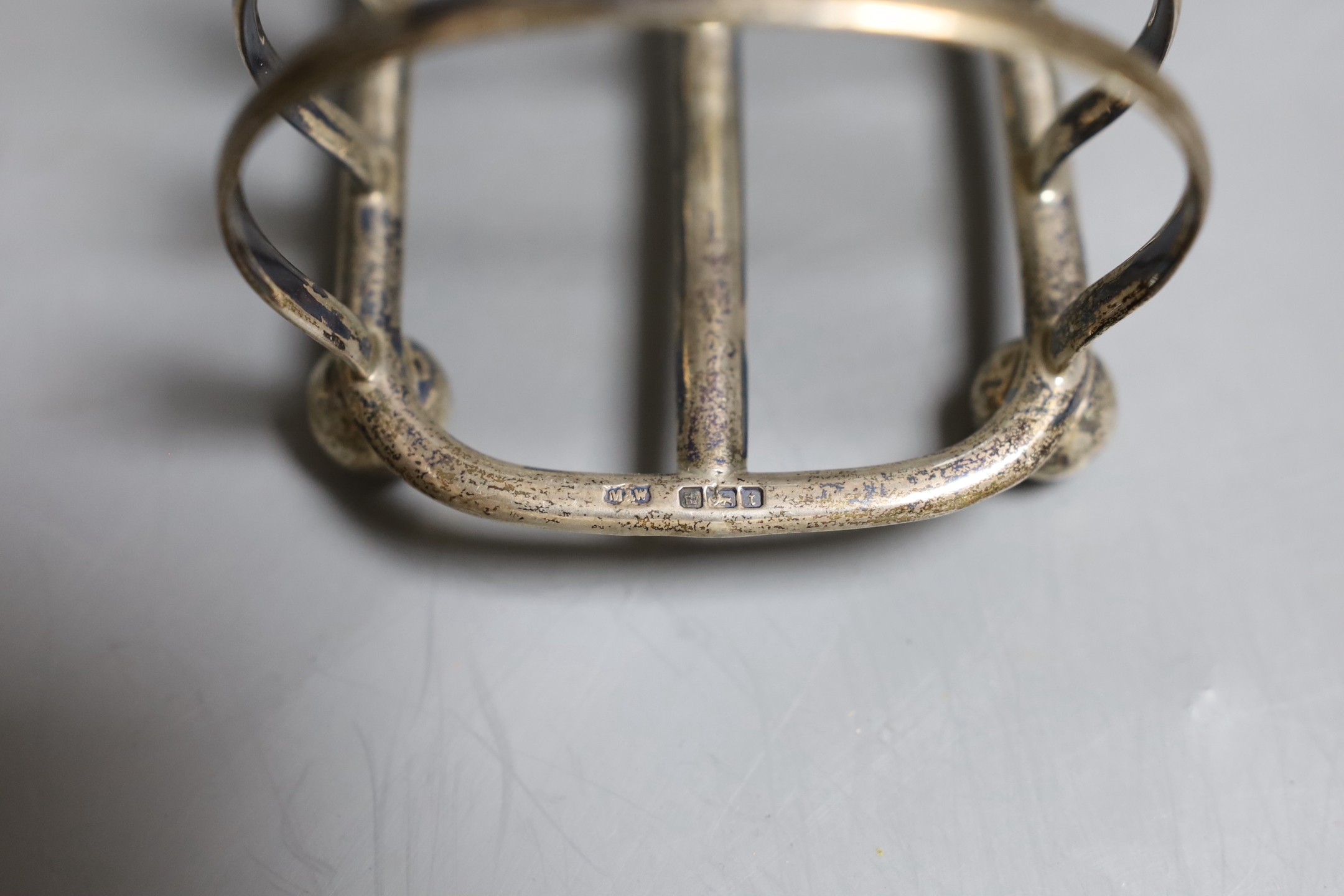 A late Victorian Irish silver seven bar toastrack, John Smyth, Dublin, 1898, length 17.5cm and one other later smaller toastrack by Mappin & Webb, 15.5oz.